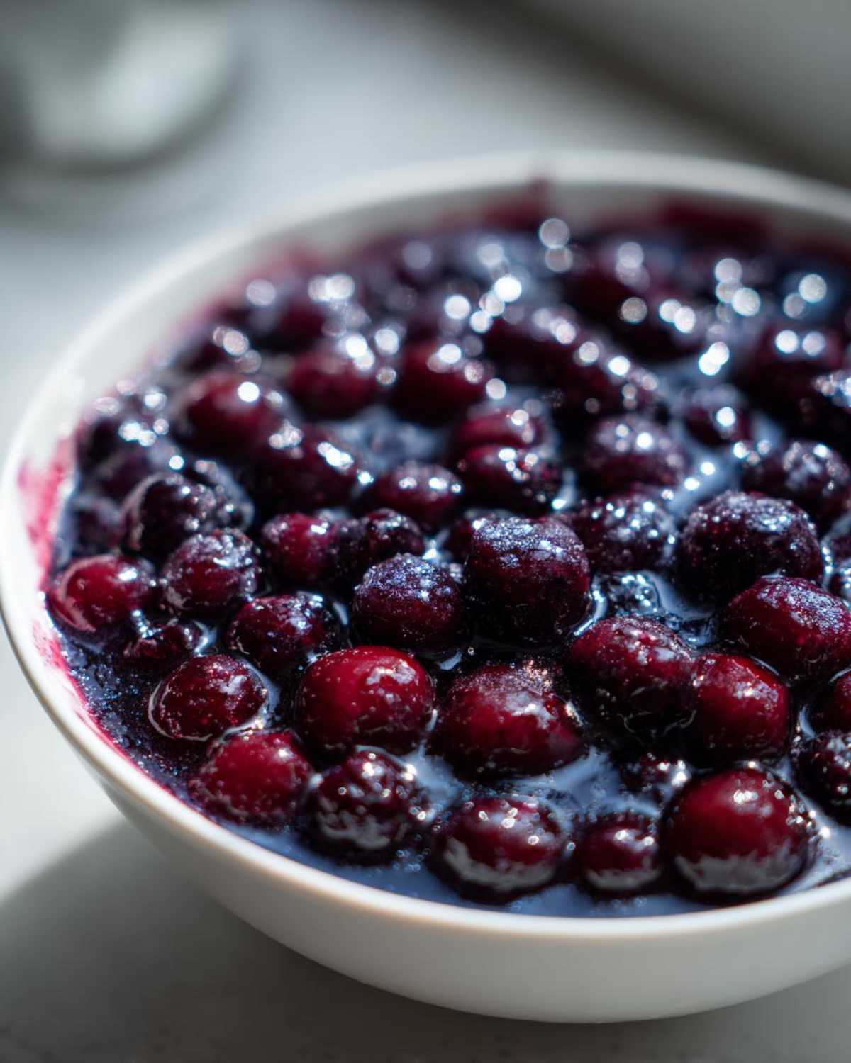 Close-up of rich, dark blackberries simmering in syrup, ready for Blackberry Dumplings.