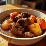 Close-up of tender chunks of beef and vegetables in a rich gravy, representing the amazing crockpot beef stew.