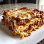 Close-up of a perfectly layered slice of instant pot lasagna with rich meat sauce and melted cheese.