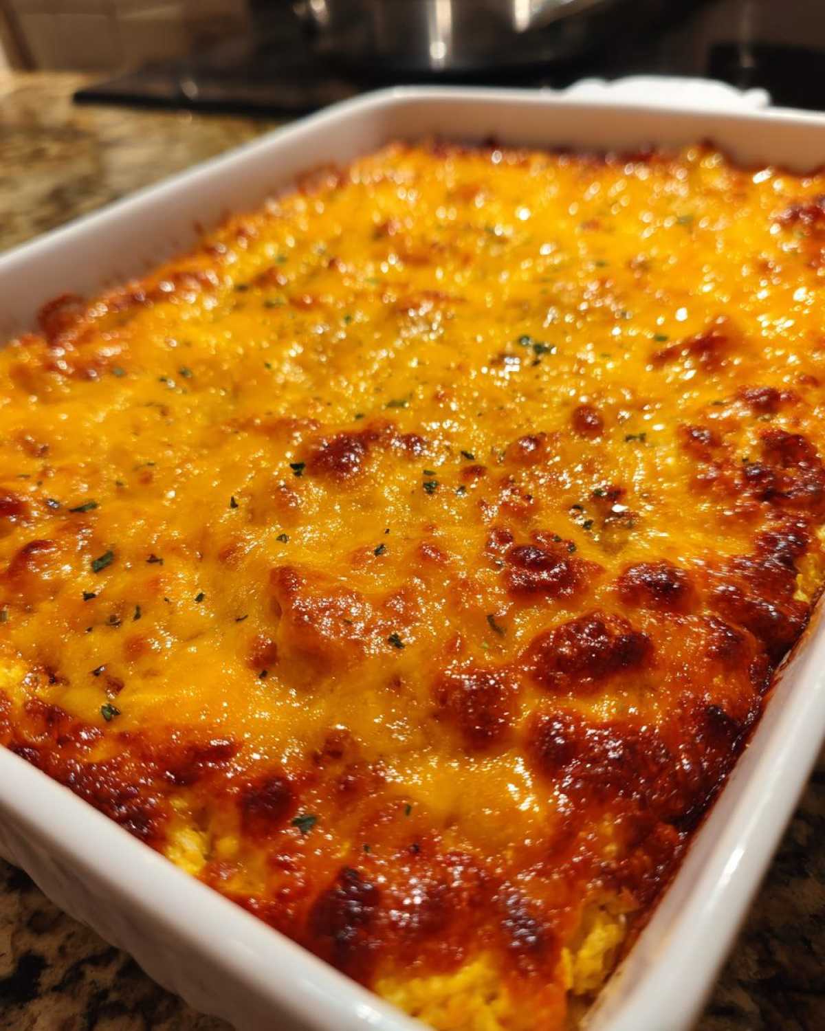 Close-up of a freshly baked chili cheese dip with a bubbly, golden-brown melted cheese topping.