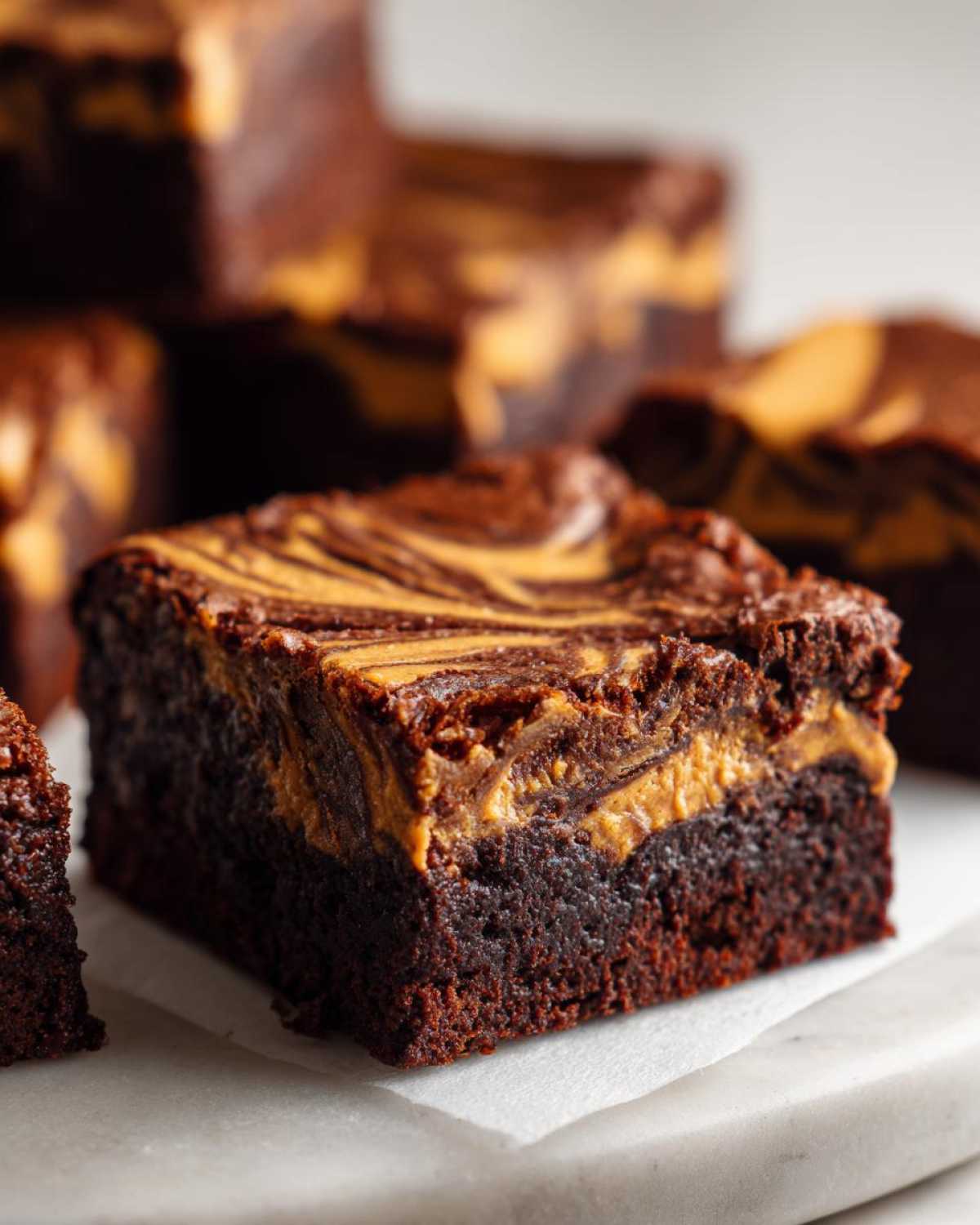 A rich, fudgy square of peanut butter swirl brownies showing a distinct peanut butter ribbon pattern on top.