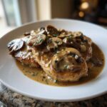 Three pieces of pan-seared chicken covered in a rich, brown mushroom sauce, representing delicious chicken marsala.