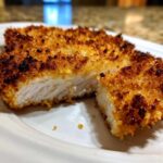 Close-up of Air Fryer Crispy Pork Schnitzel Cutlets, showing the juicy white meat and golden, crunchy breading.