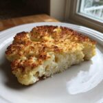 A perfectly cooked slice of Air Fryer Garlic Parmesan Cauliflower Steak with a golden brown, crispy topping.