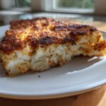 Close-up of a crispy, golden-brown Air Fryer Garlic Parmesan Cauliflower Steak with a bite taken out.