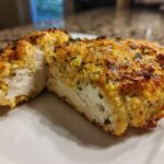 Cross-section of juicy baked ranch chicken showing the white interior and golden, herbed crust.
