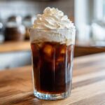 Close-up of iced coffee topped generously with Copycat Starbucks Vanilla Sweet Cream Cold Foam.