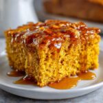 Close-up of a slice of moist sweet potato cornbread generously drizzled with golden syrup.