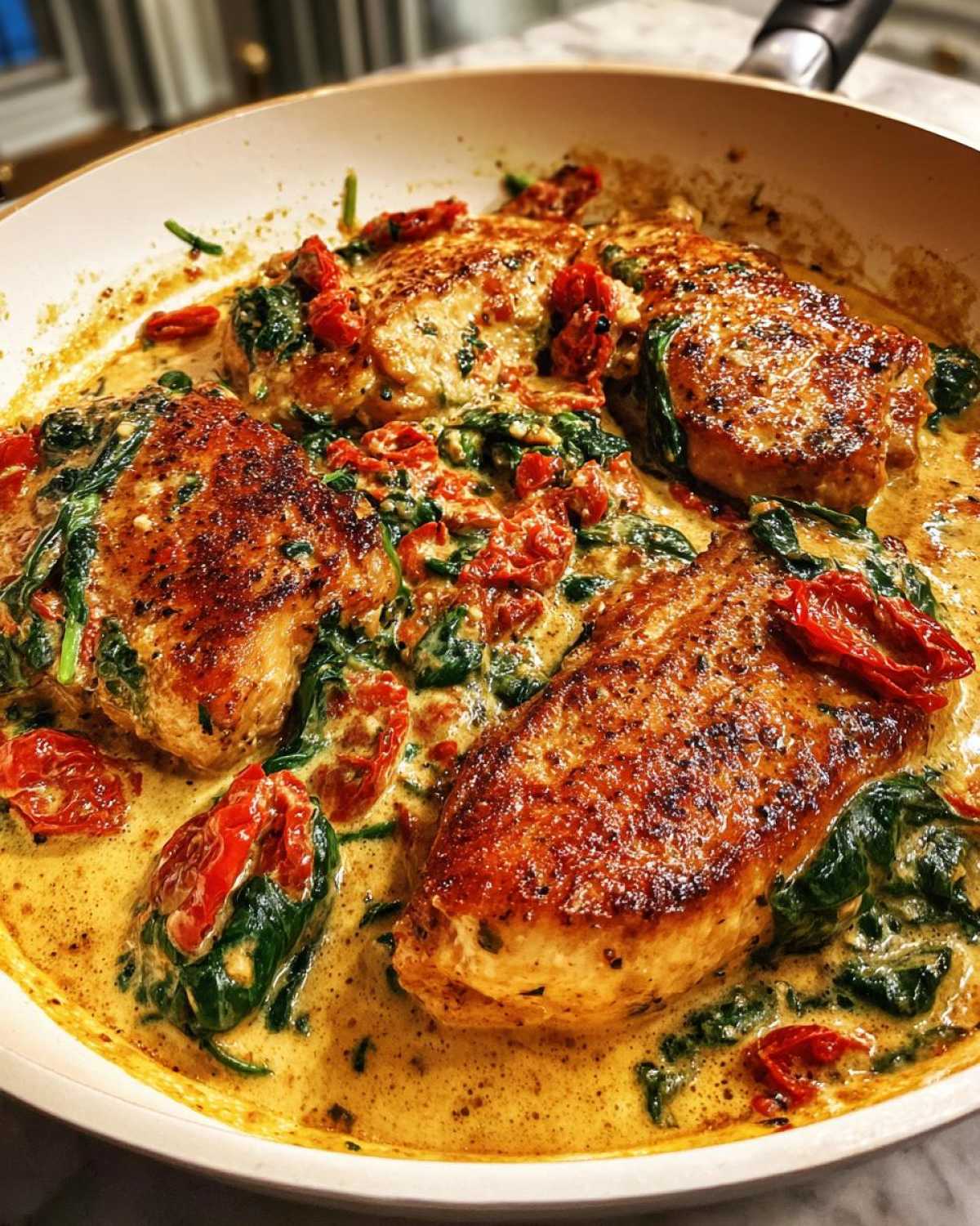 Four seared One-Pan Creamy Garlic Butter Turkey Cutlets simmering in a rich sauce with spinach and sun-dried tomatoes.