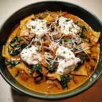 Close-up of a bowl of One-Pot Creamy Spinach Mushroom Lasagna Soup topped with dollops of ricotta and shredded Parmesan.